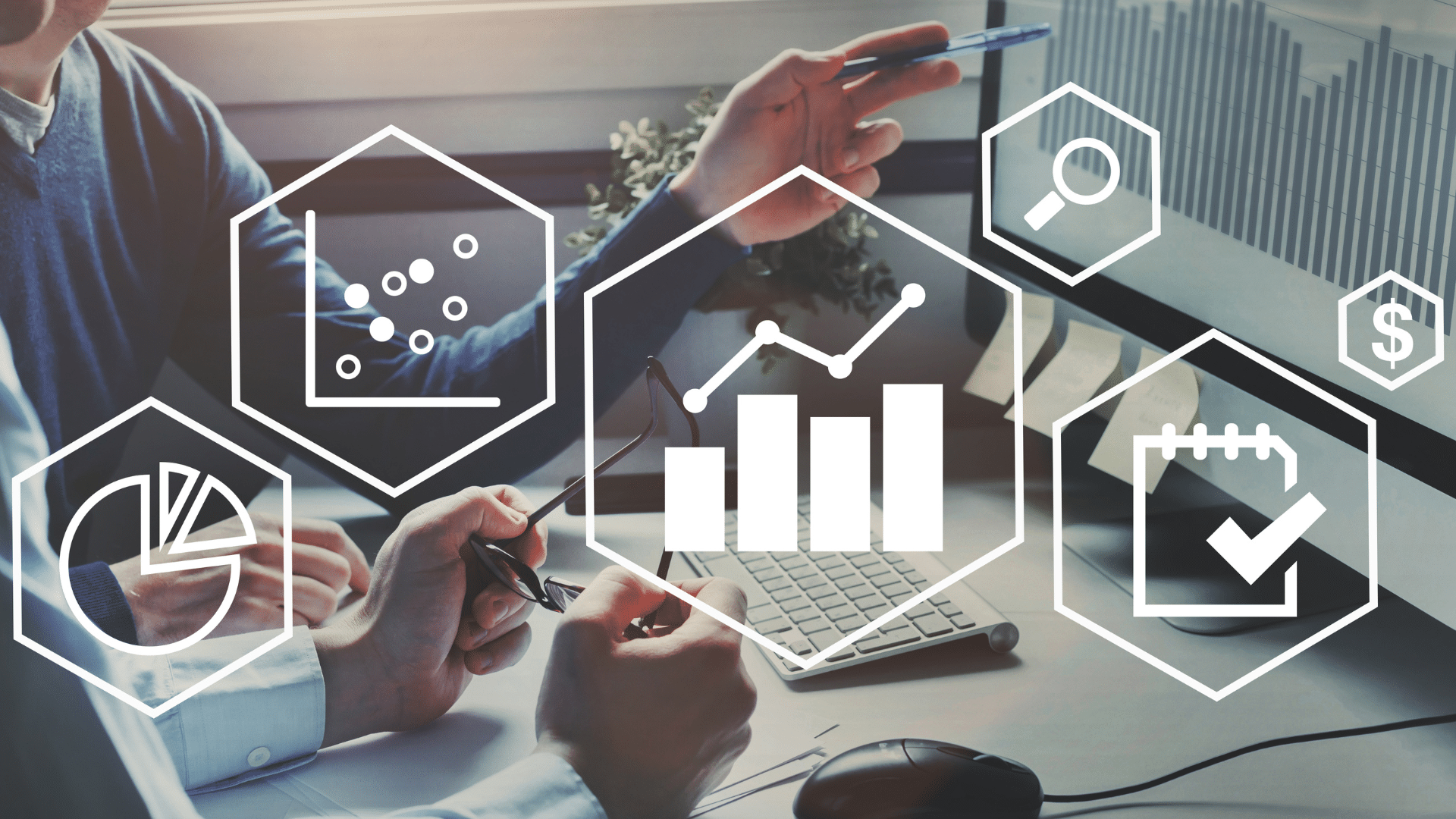 People discussing data and charts on a computer with analytics icons overlayed.
