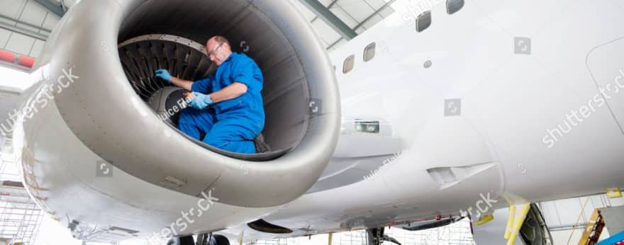 An aerospace engineer working inside a plane propellor