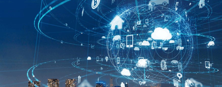 City skyline at night with digital network and cloud computing icons overlaid.
