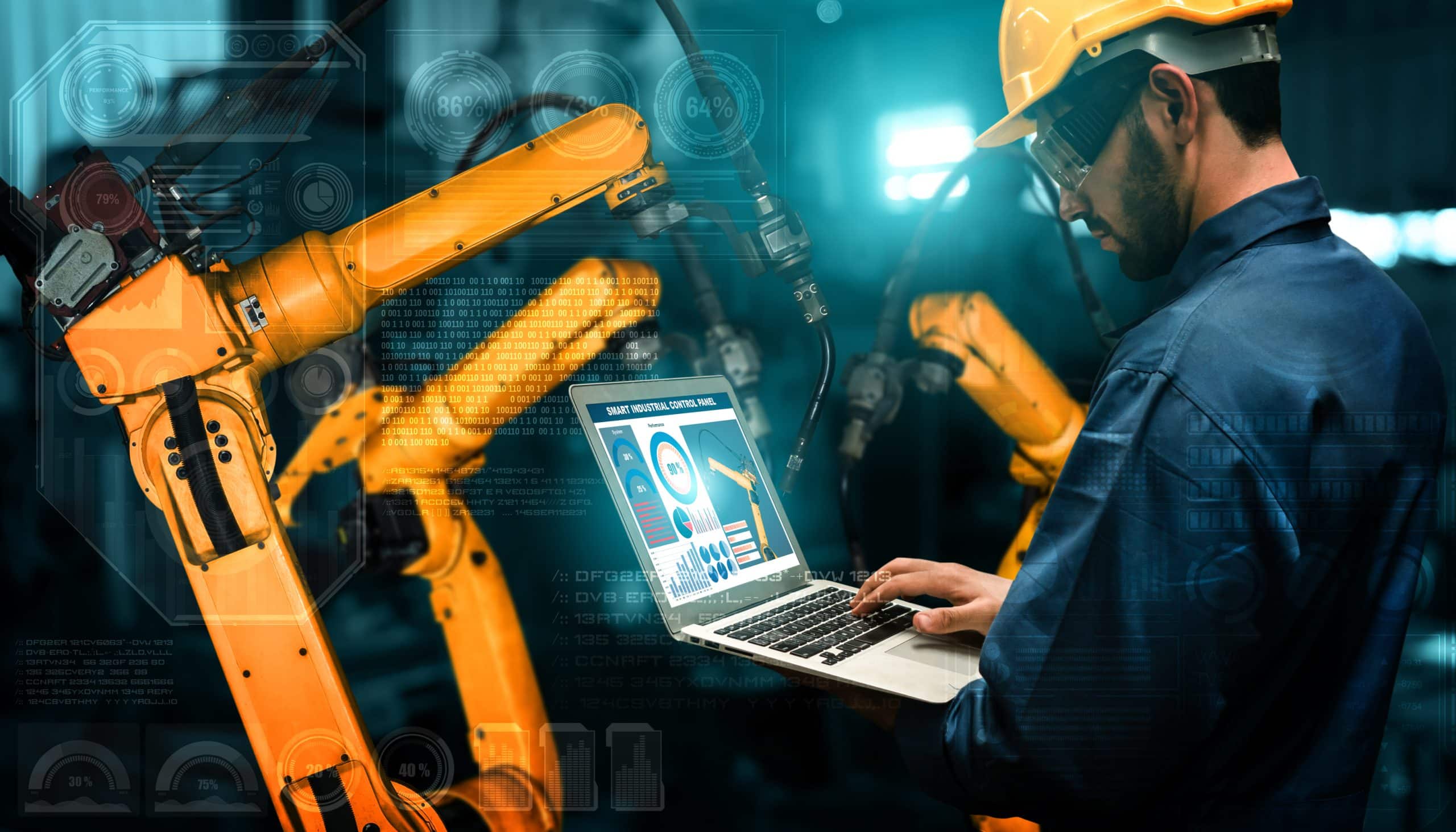 Engineer using a laptop to monitor industrial robots in a factory with digital interface graphics.