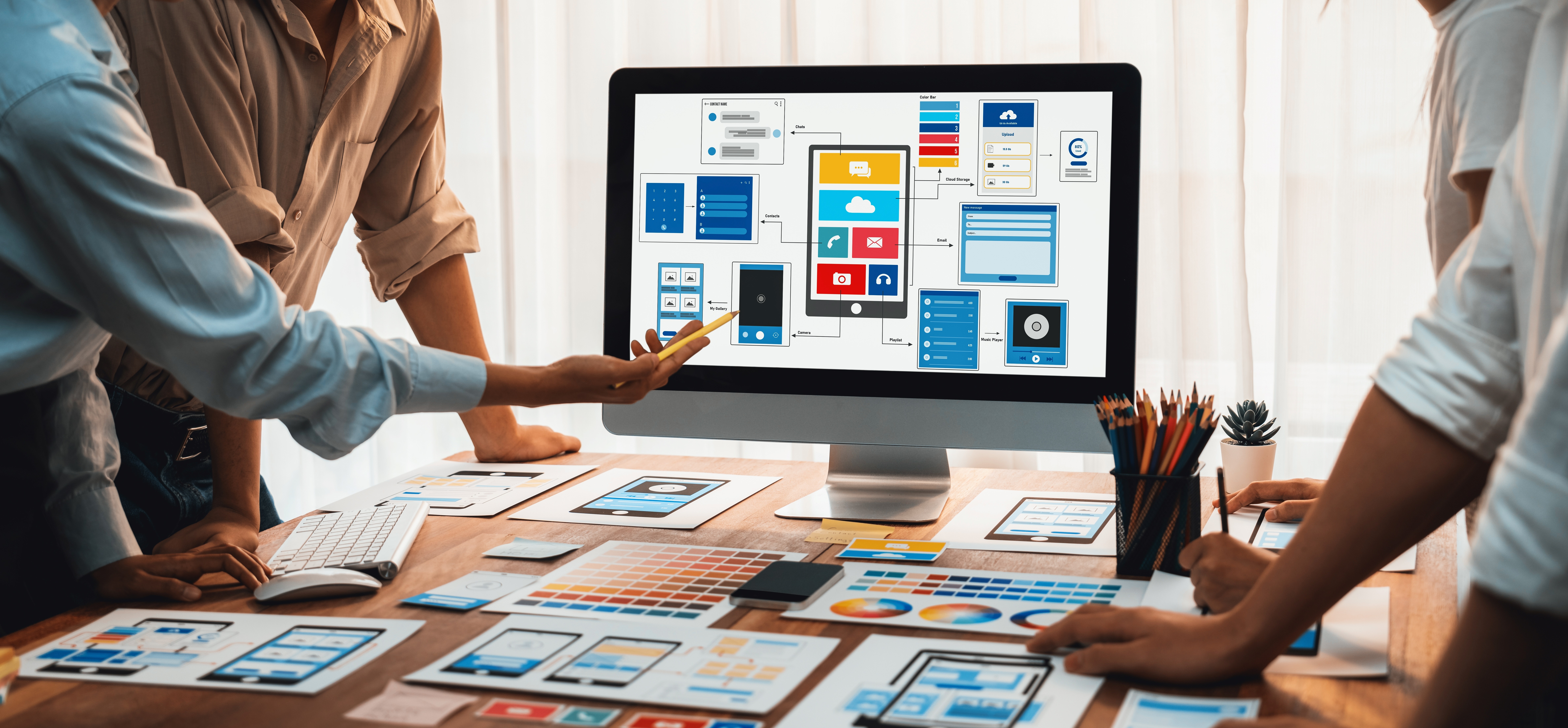 Group of people collaborating on app design with diagrams displayed on a computer screen.