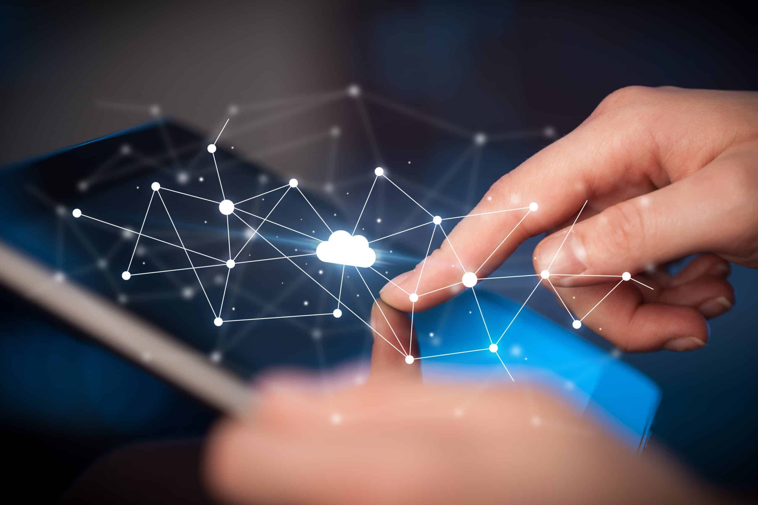Finger touching a tablet screen with a cloud computing network graphic overlay.