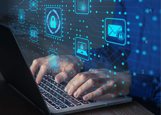 Hands typing on a laptop with digital cybersecurity icons overlayed, including padlocks and email.