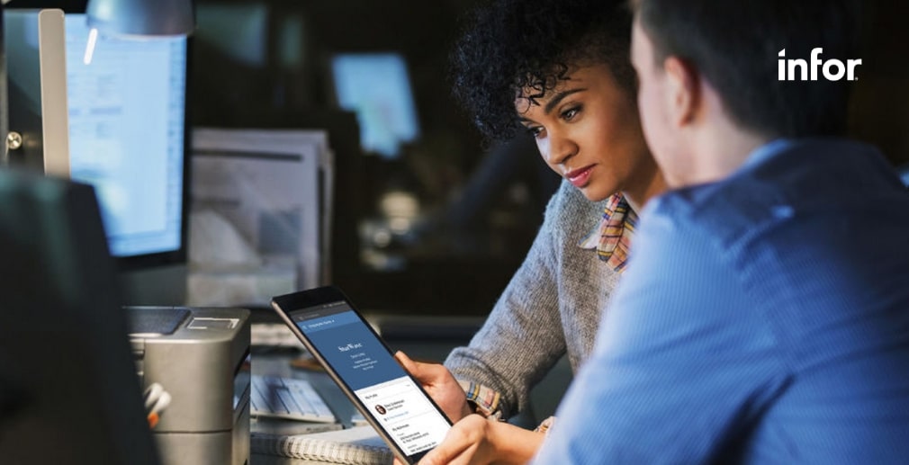 Two people looking at a tablet device in an office, with the Infor logo in the corner.