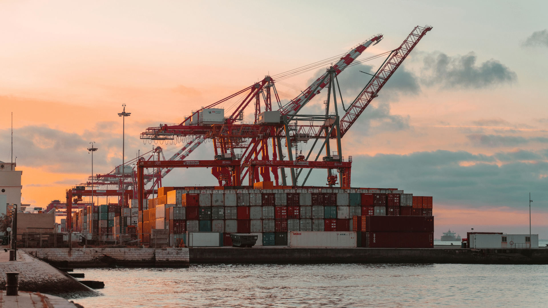 Website blog covers – Energy (16) Shipping containers and cranes at a port during sunset.